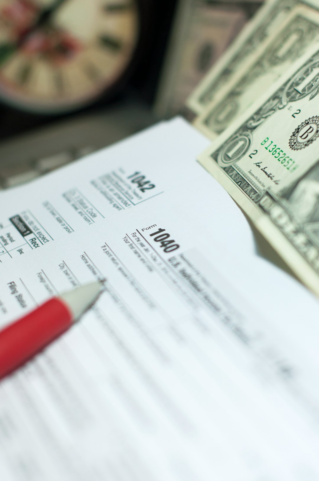 Crafting Captivating Headlines: Your awesome post title goes here Tax Season: 1040 U.S. Individual Income Tax Return Form horizontal top view with an office laptop and blue calculator as background together with a red white pen preparation on taxation as foreground